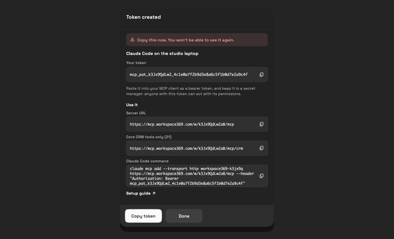 The Token created dialog on desktop in dark mode: the token with a copy button, then a Use it section with the Server URL, the Core CRM tools only address, a ready Claude Code command and a Setup guide link.
