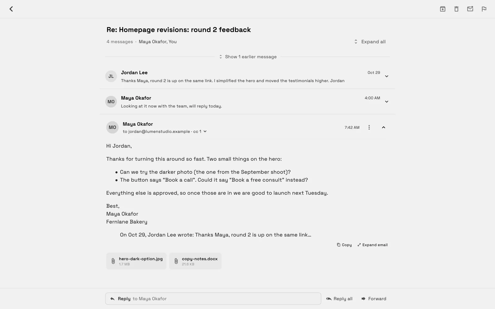 An email thread on a computer titled Re: Homepage revisions: round 2 feedback, with 4 messages · Maya Okafor, You, a Show 1 earlier message line, the latest message open with two attachments, and a Reply to Maya Okafor field with Reply all and Forward.